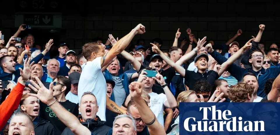 Football fans cheering and celebrating in stadium