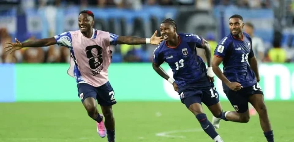 Three players celebrating a goal during match