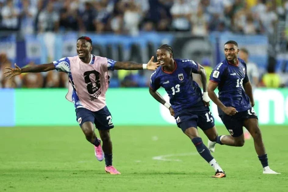 Three players celebrating a goal during match