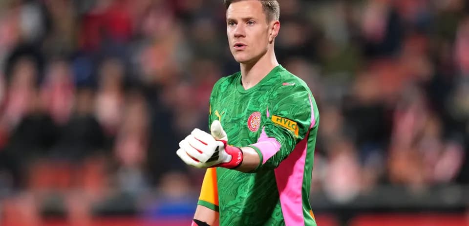 Goalkeeper gesturing during match in colorful kit
