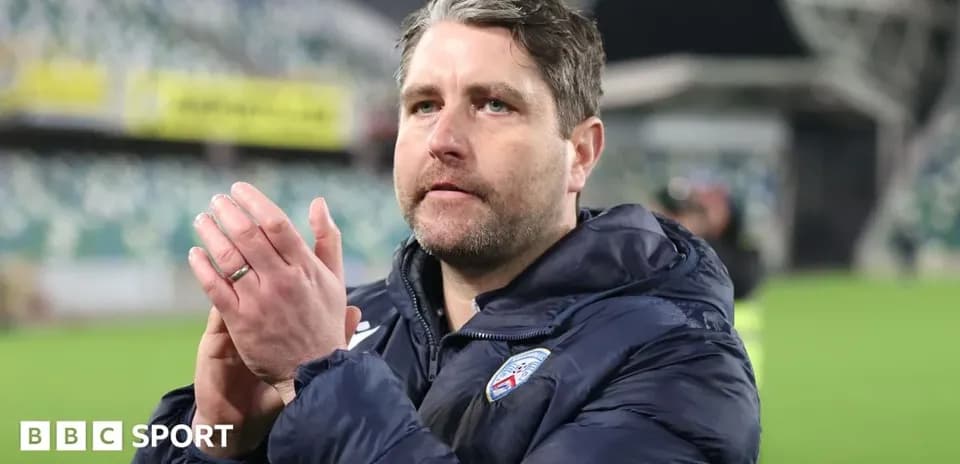 Coach applauding fans after a match