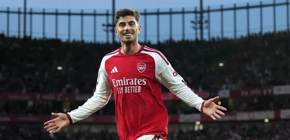 Futbolchi maydonda quvonch bilan qo'llarini ochmoqda