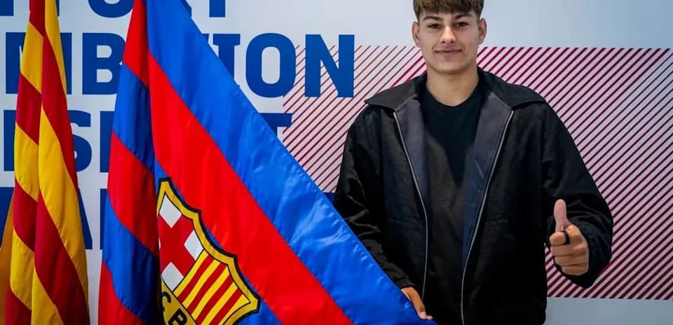 Young player posing with FC Barcelona flag