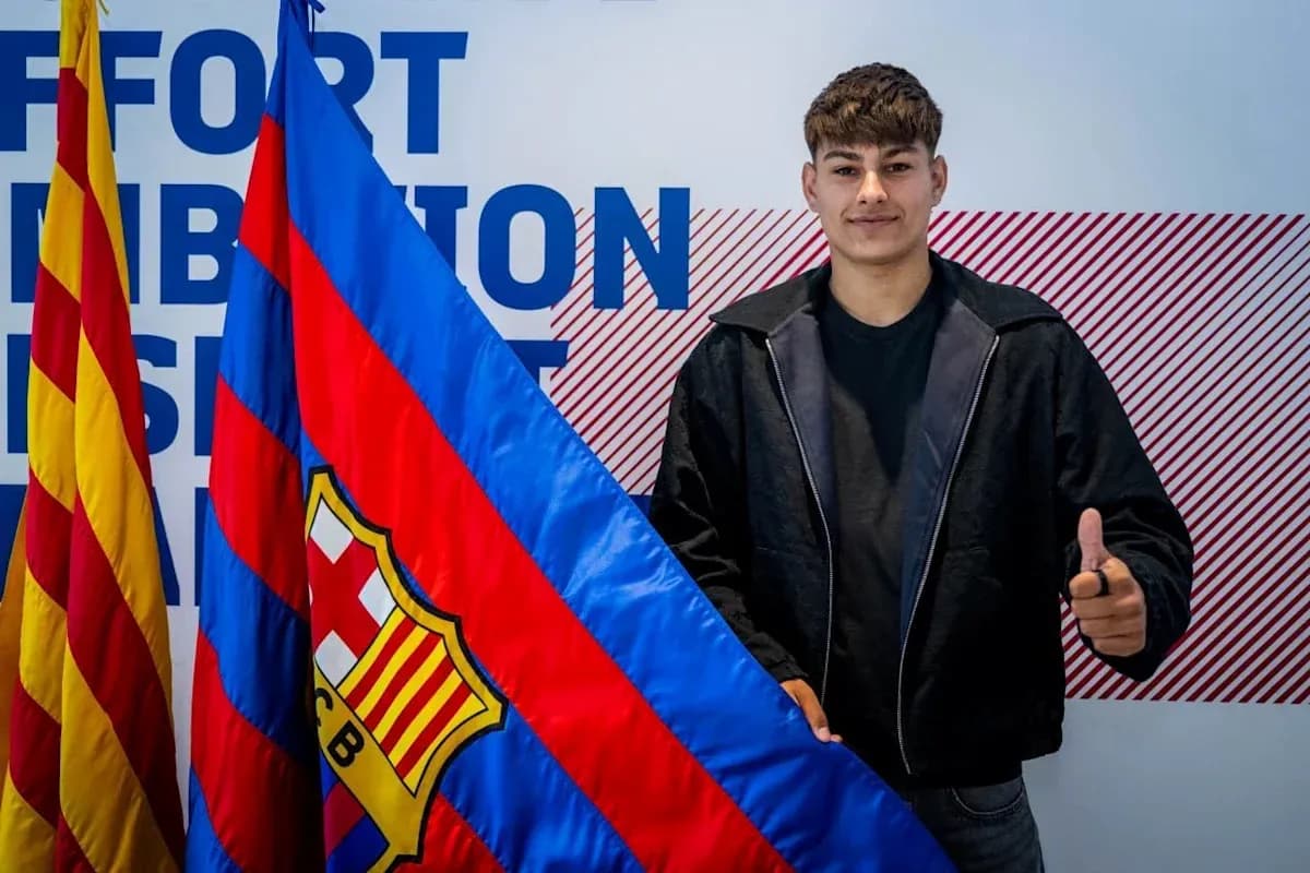 Young player posing with FC Barcelona flag