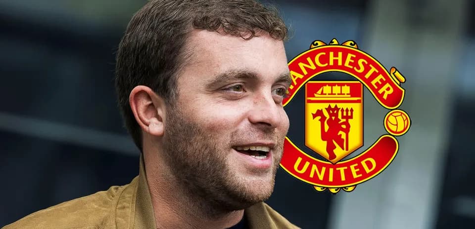Shirted man smiling with Manchester United logo background