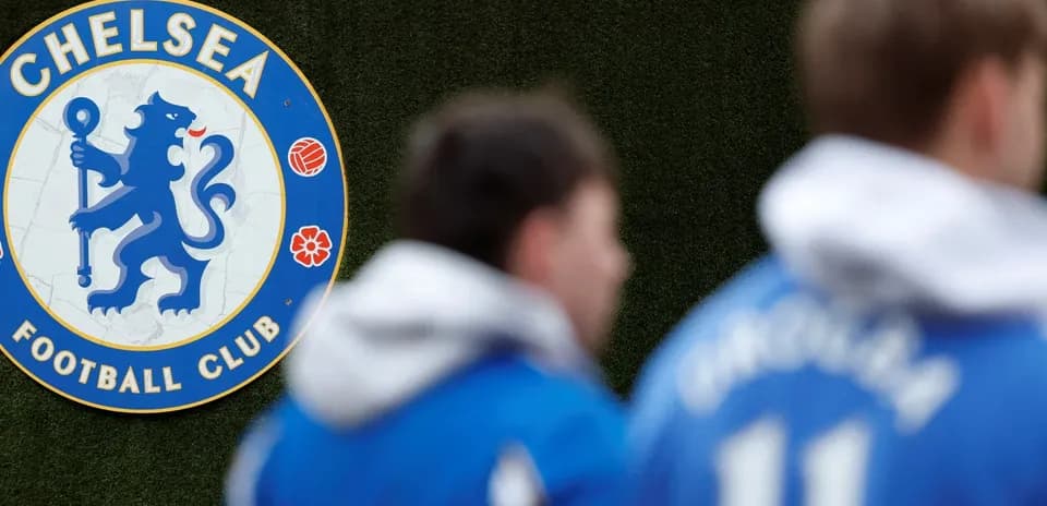Chelsea FC logo with players in blue jerseys