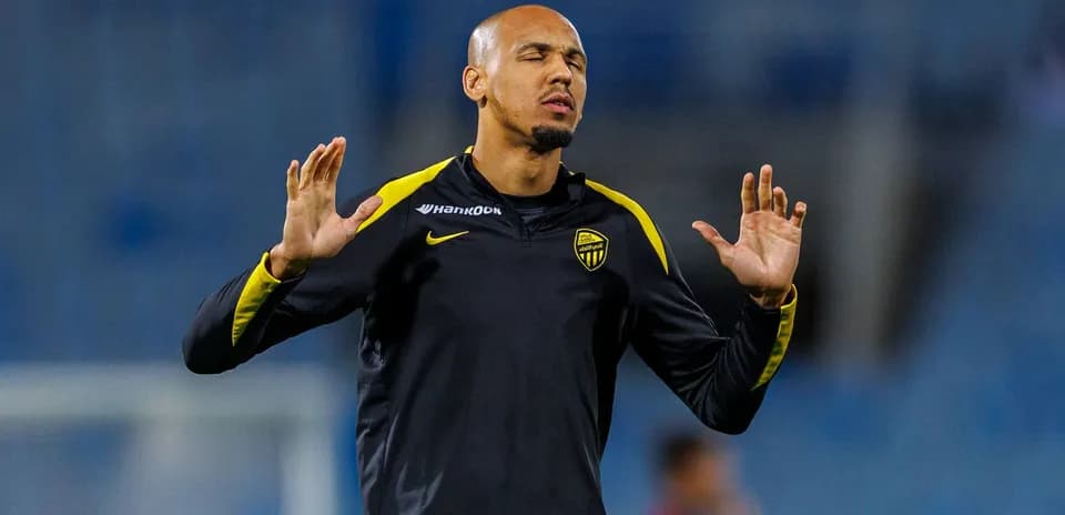 Futbolchi mashg'ulotda qo'llarini ko'tarib turibdi