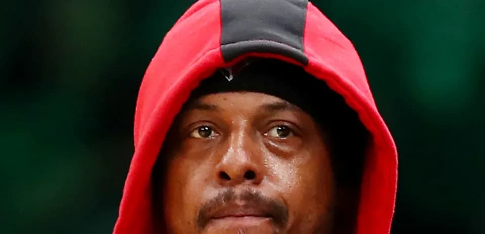 Basketball player wearing red hoodie, focused expression