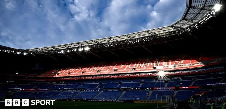 Stadium interior with empty seats and cloudy sky