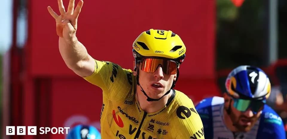 Bicyclist in yellow jersey celebrating victory in race