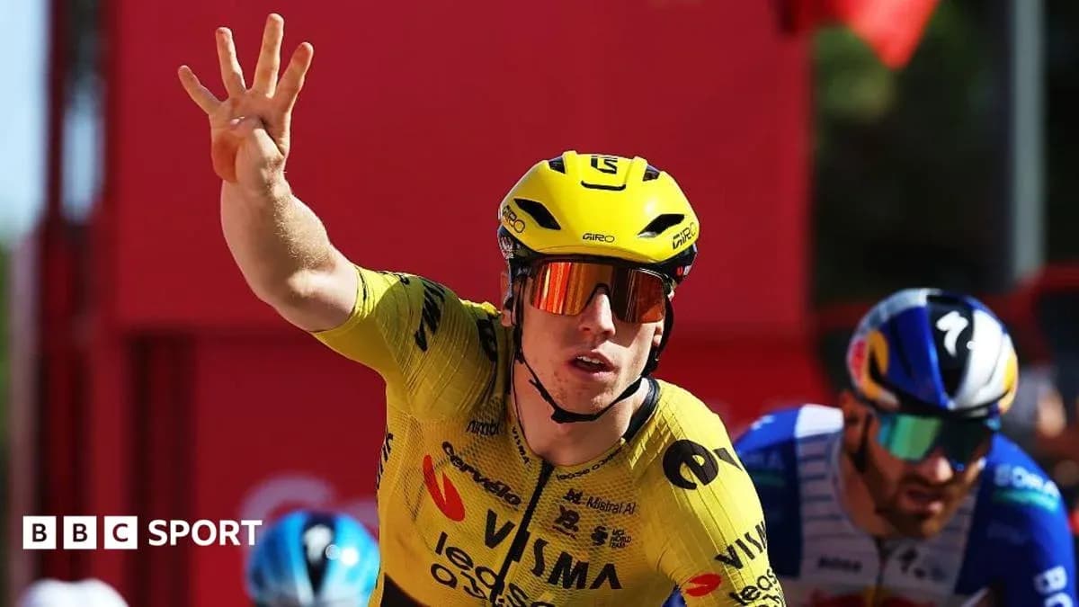 Bicyclist in yellow jersey celebrating victory in race