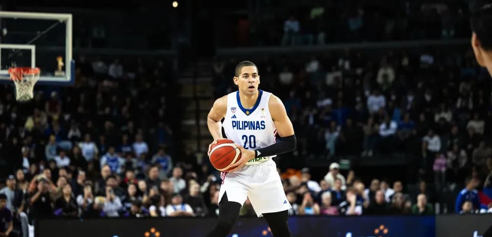 Basketball player dribbling ball on court