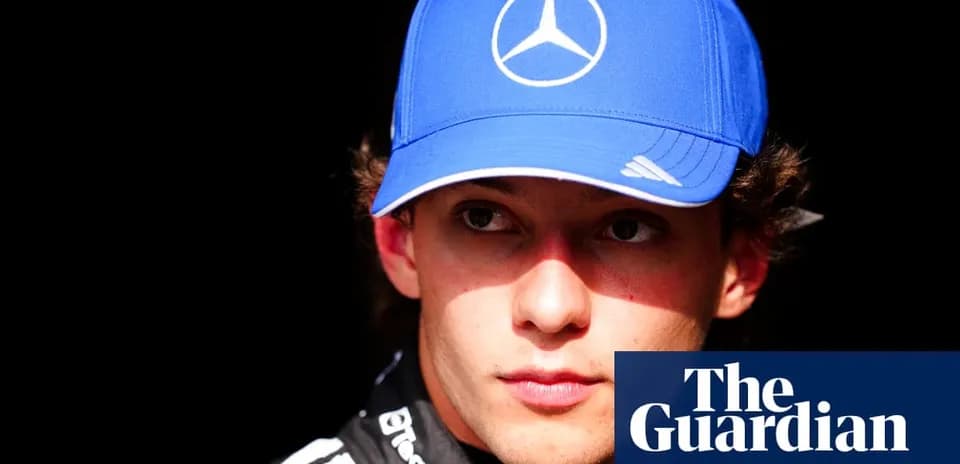 Yoshida wearing a blue Mercedes cap in focus