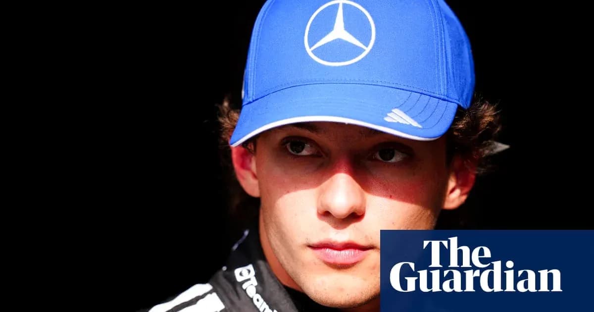 Yoshida wearing a blue Mercedes cap in focus