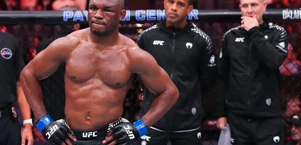 MMA fighter in octagon with coaches behind