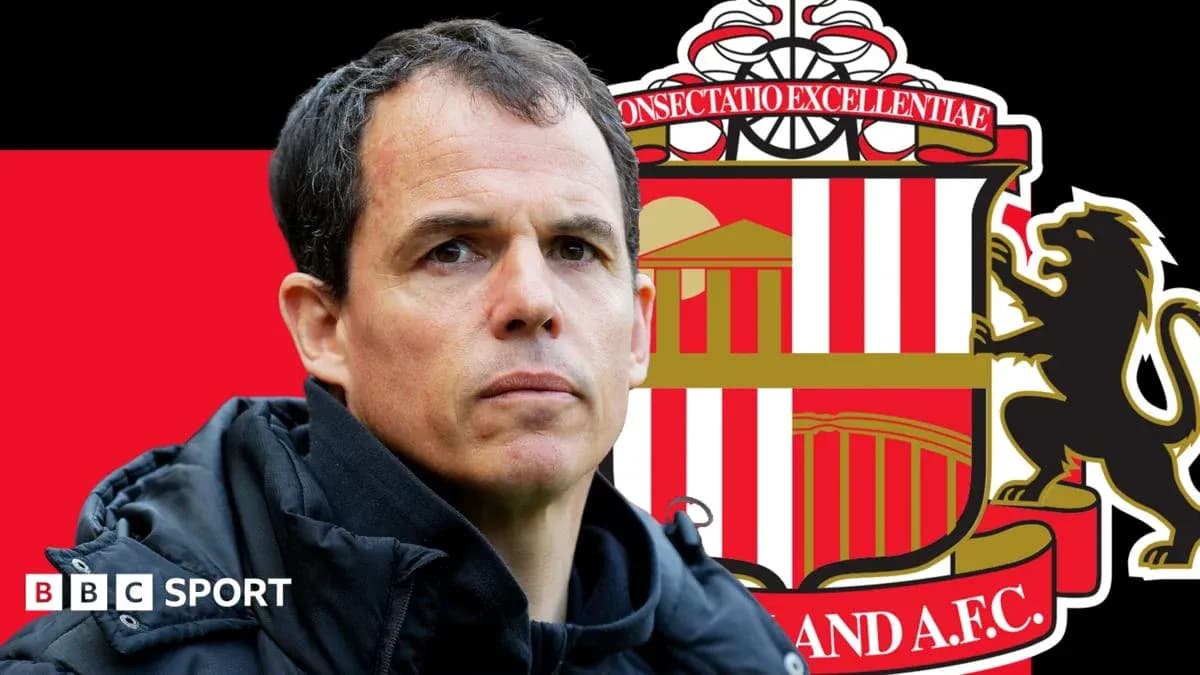 Sunderland manager in front of club logo