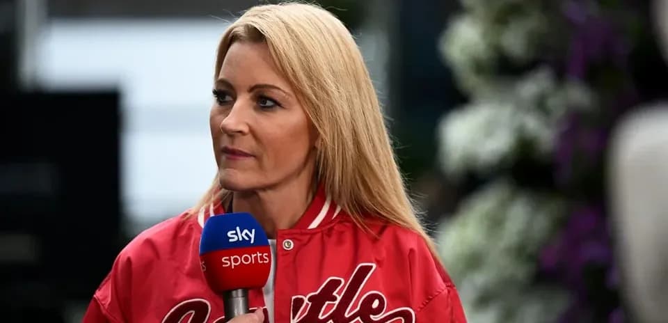 Television presenter speaking into microphone on set