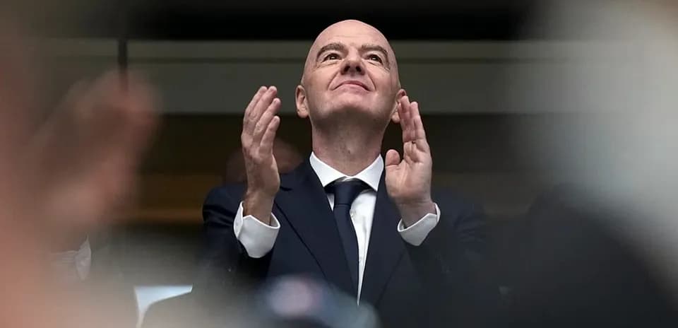 Man in suit applauding at an event