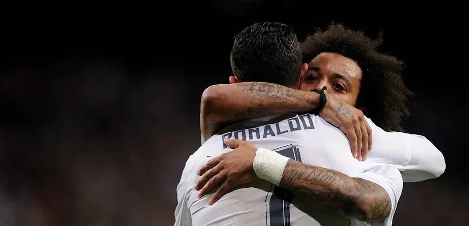 Cristiano Ronaldo and Marcelo hugging on the pitch