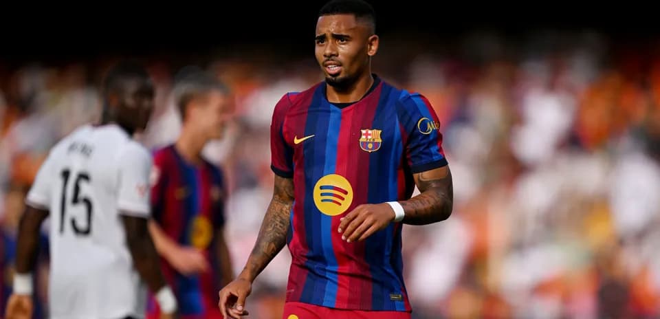 Barcelona player walking on field during match