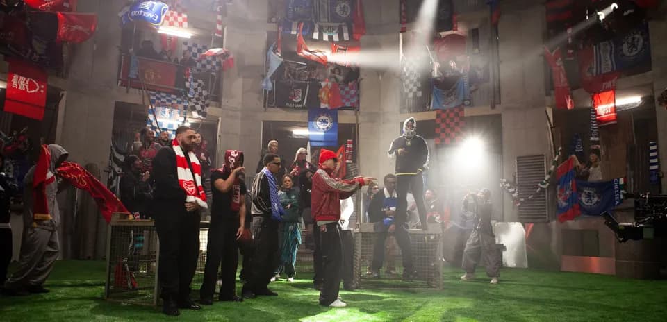Fans with flags gathered in a stadium-like setting
