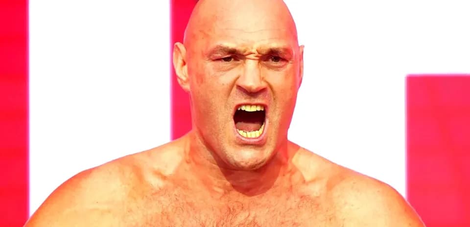 Bald fighter shouting on stage with red background
