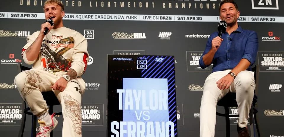 Jake Paul and promoter discussing fight details at podium