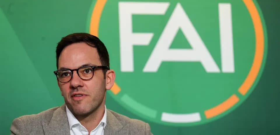 Man speaking at FAI press conference backdrop