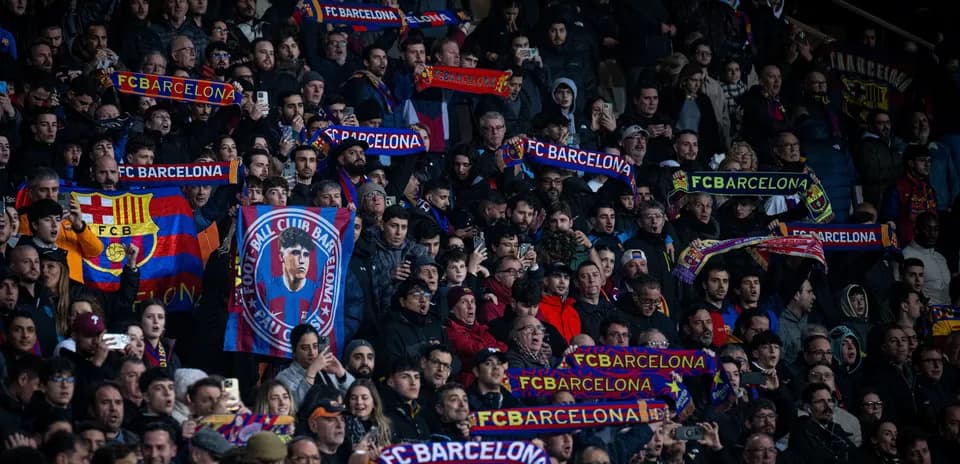 FC Barcelona fans cheering with scarves in stadium