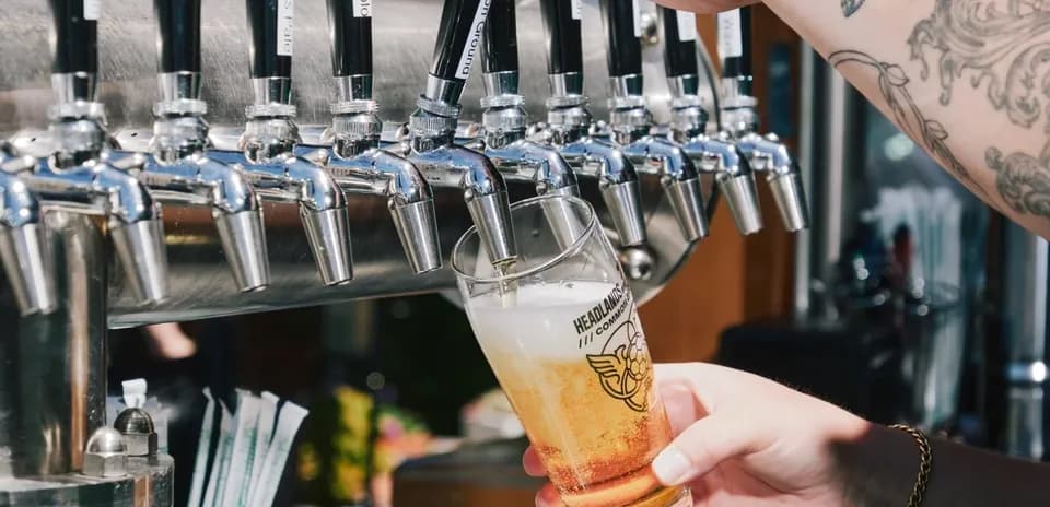 Pint glass being filled from beer tap