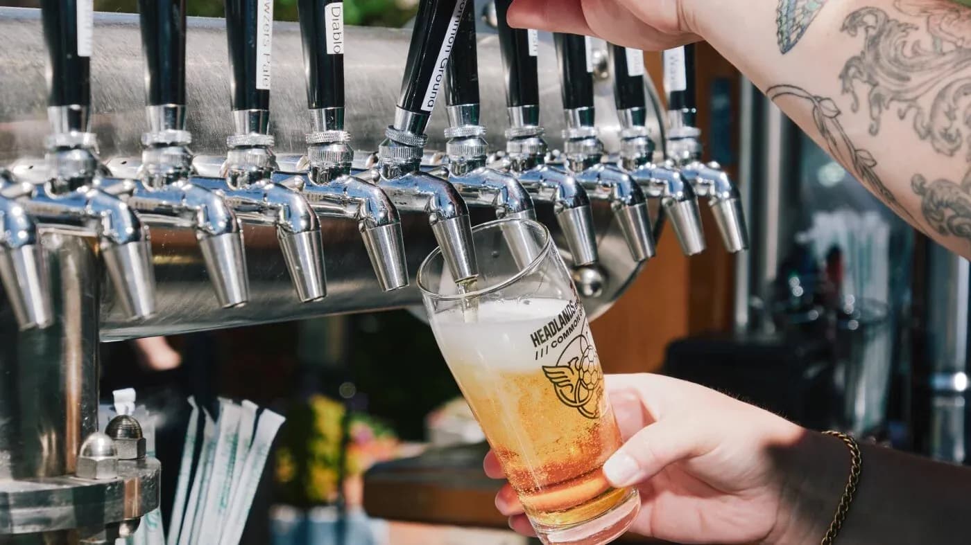 Pint glass being filled from beer tap