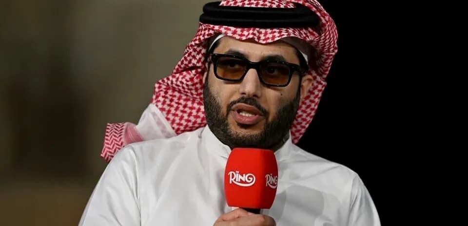 Shirted man speaking into microphone during interview
