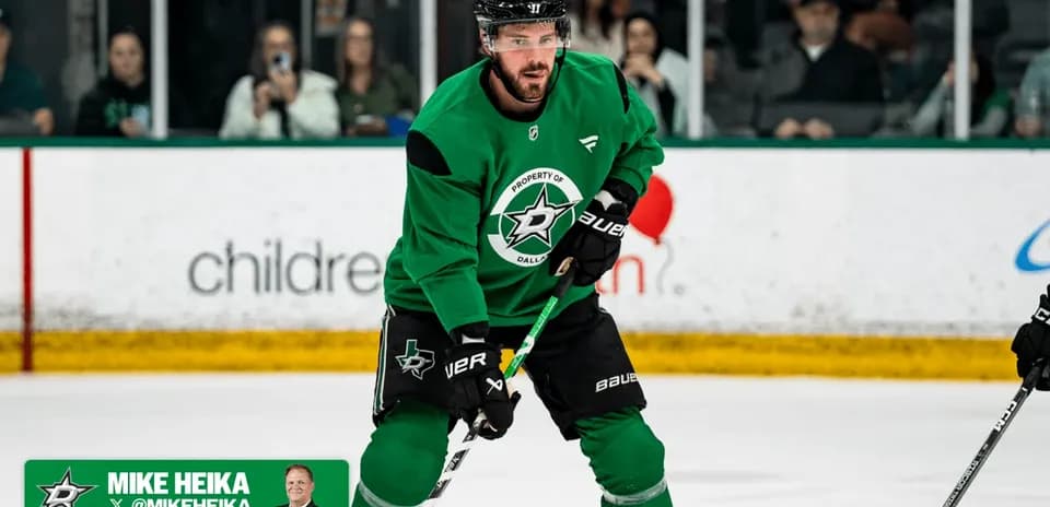 Hockey player practicing on ice rink in green jersey