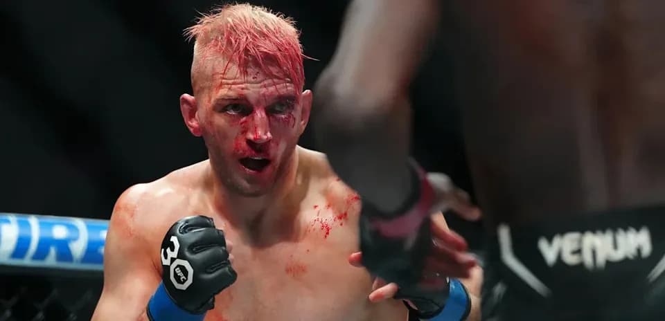 MMA fighter with blood on face in ring