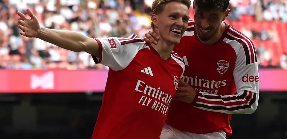 Arsenal players celebrating a goal on the pitch