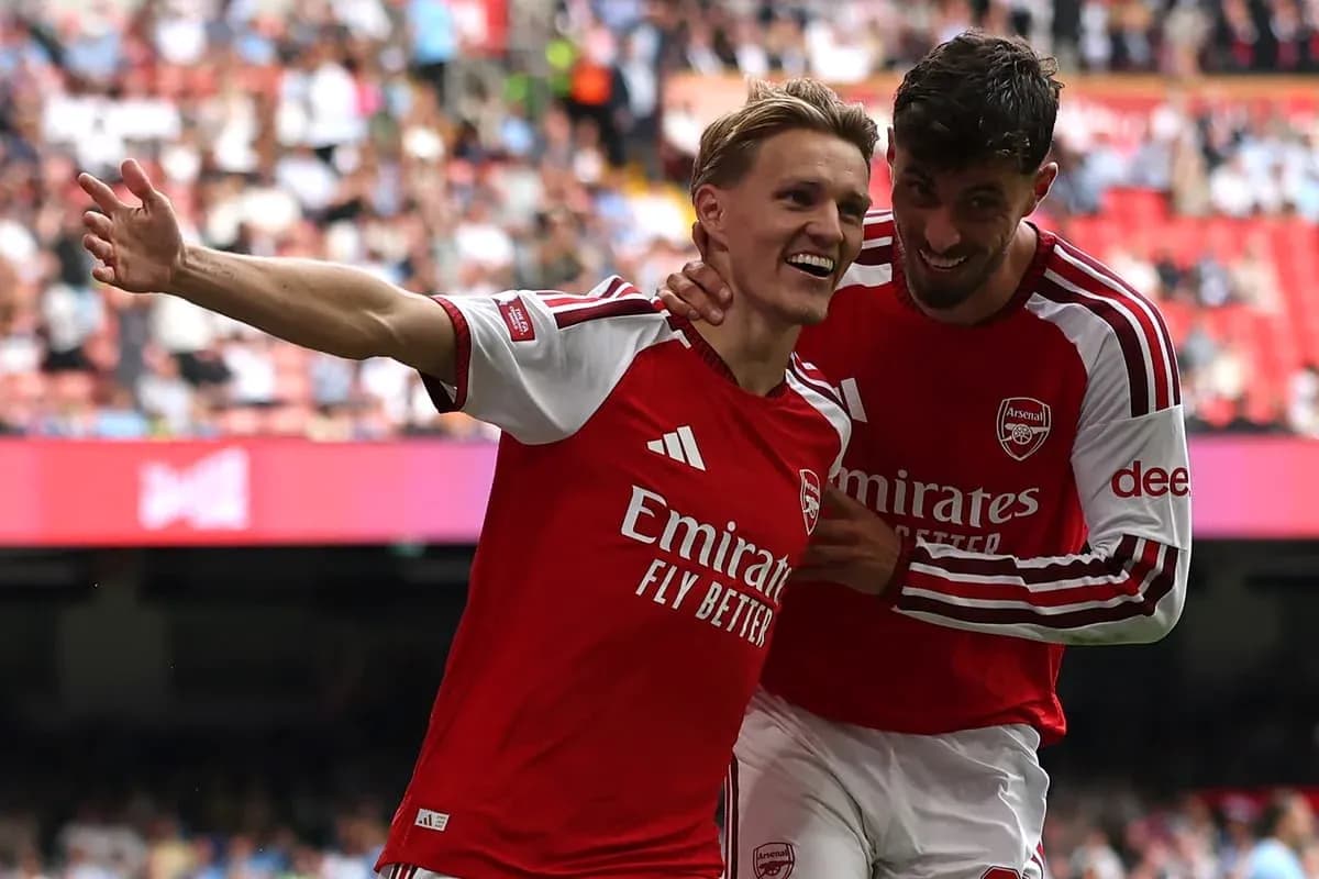 Arsenal players celebrating a goal on the pitch