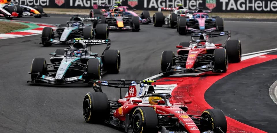 Formula 1 cars racing at a track corner
