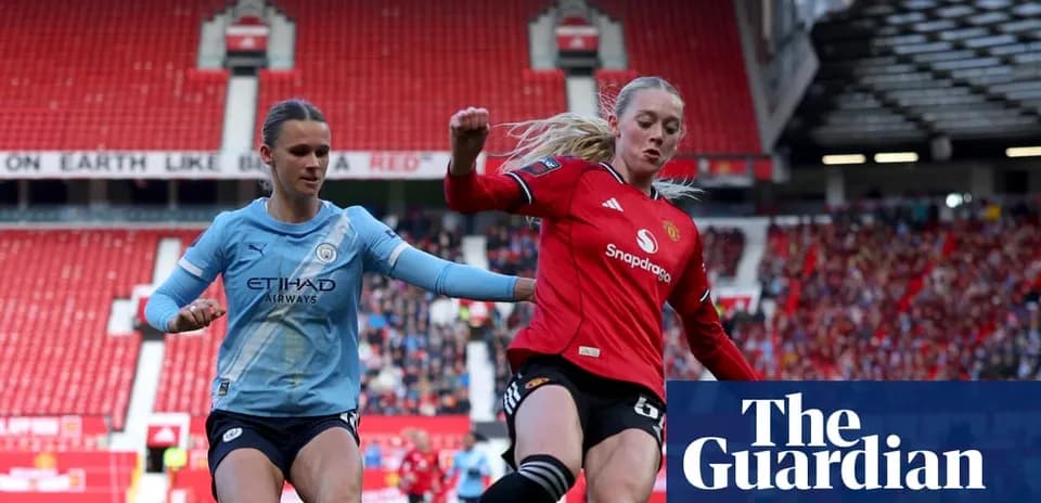 Manchester City and Manchester United players competing for ball