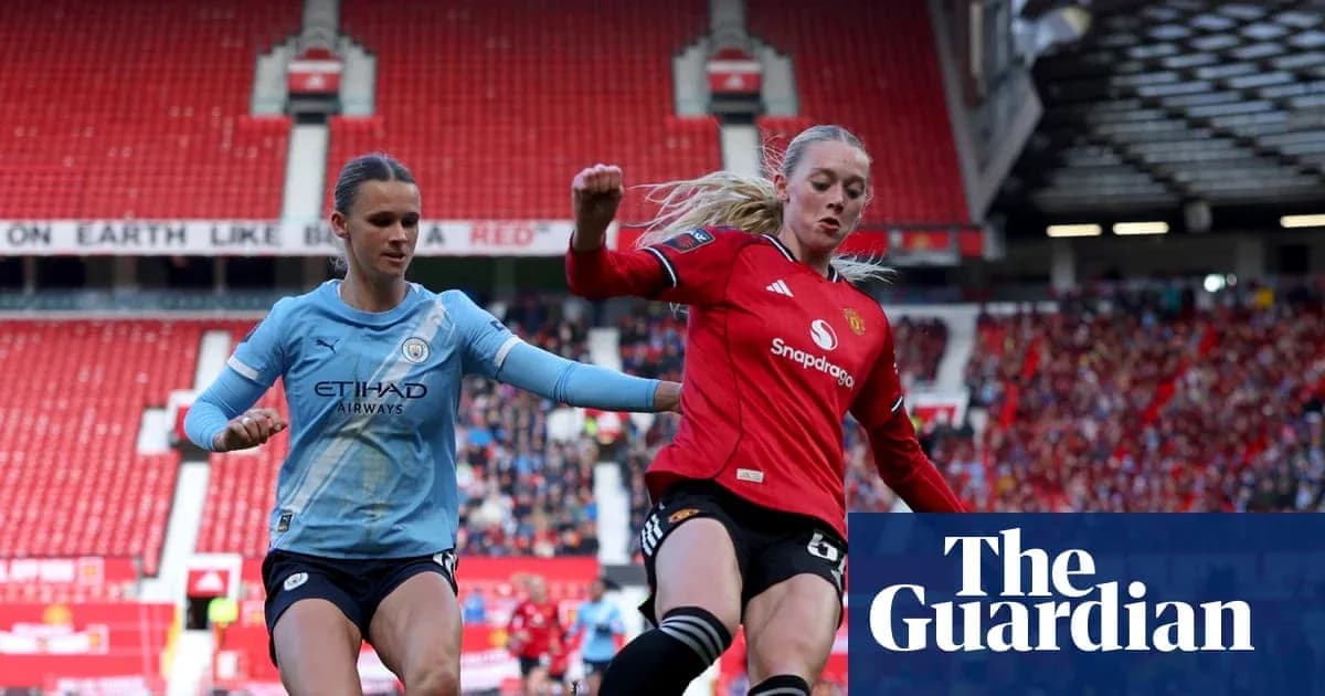 Manchester City and Manchester United players competing for ball