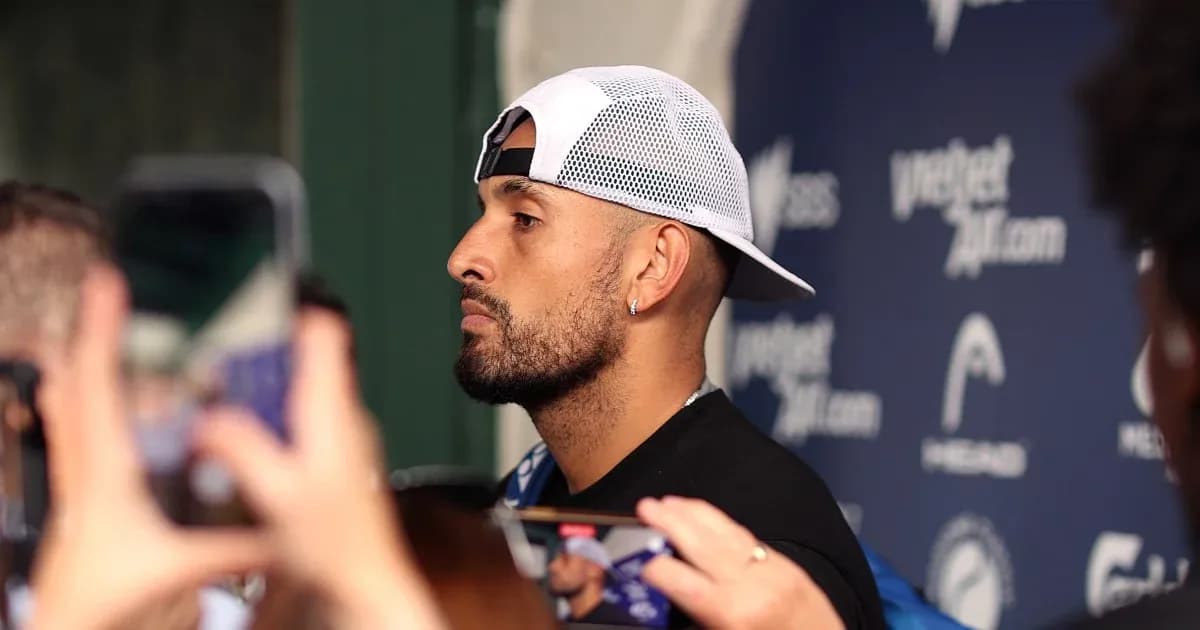 Athlete speaking to media with microphones nearby