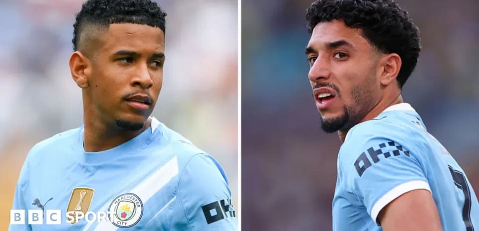 Two Manchester City players in match jerseys