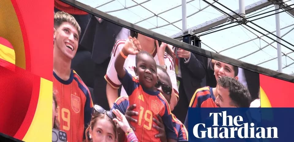 Fans celebrating with a child in Spain jersey