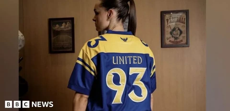 Person wearing blue and yellow sports jersey