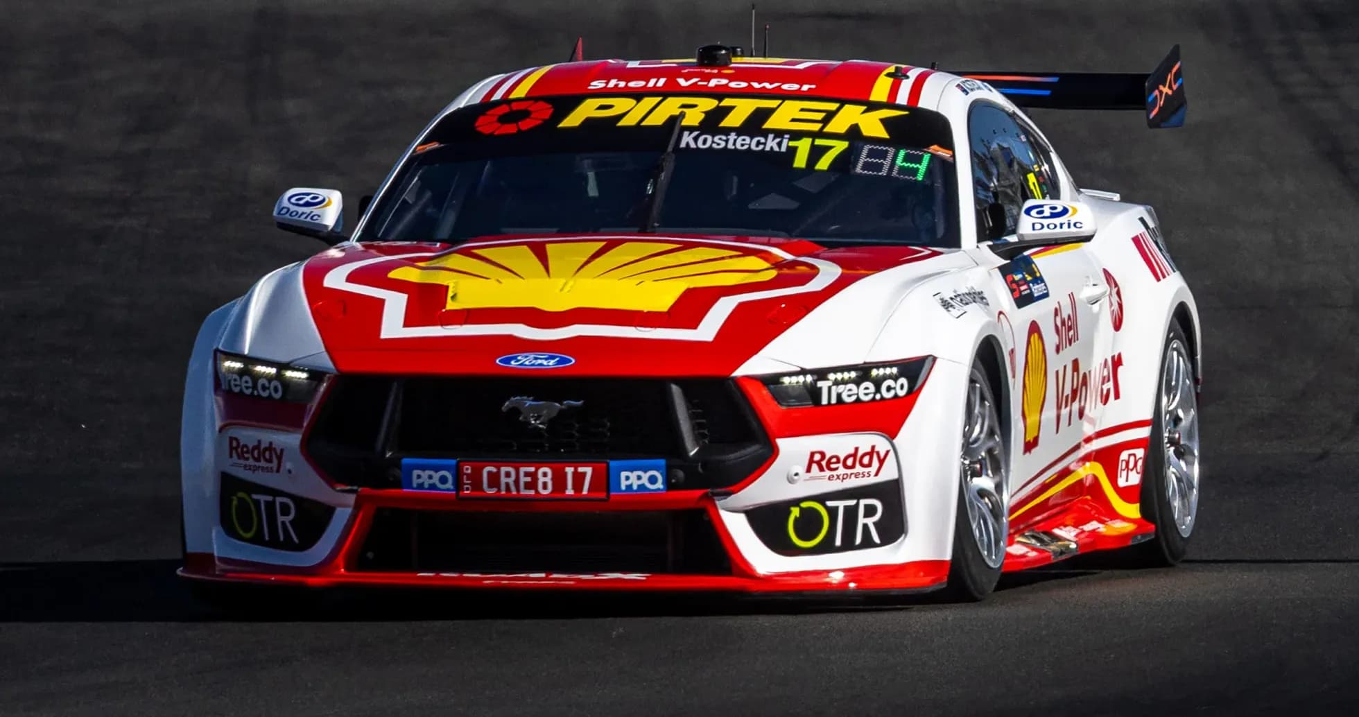 Ford Mustang race car on track during competition