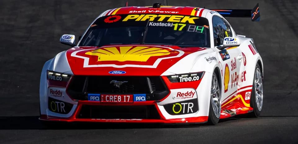 Ford Mustang race car on track during competition