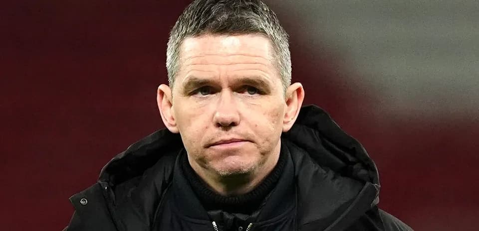 Men's football coach on the field during match