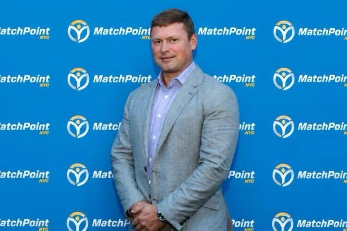 Man posing in front of MatchPoint NYC backdrop