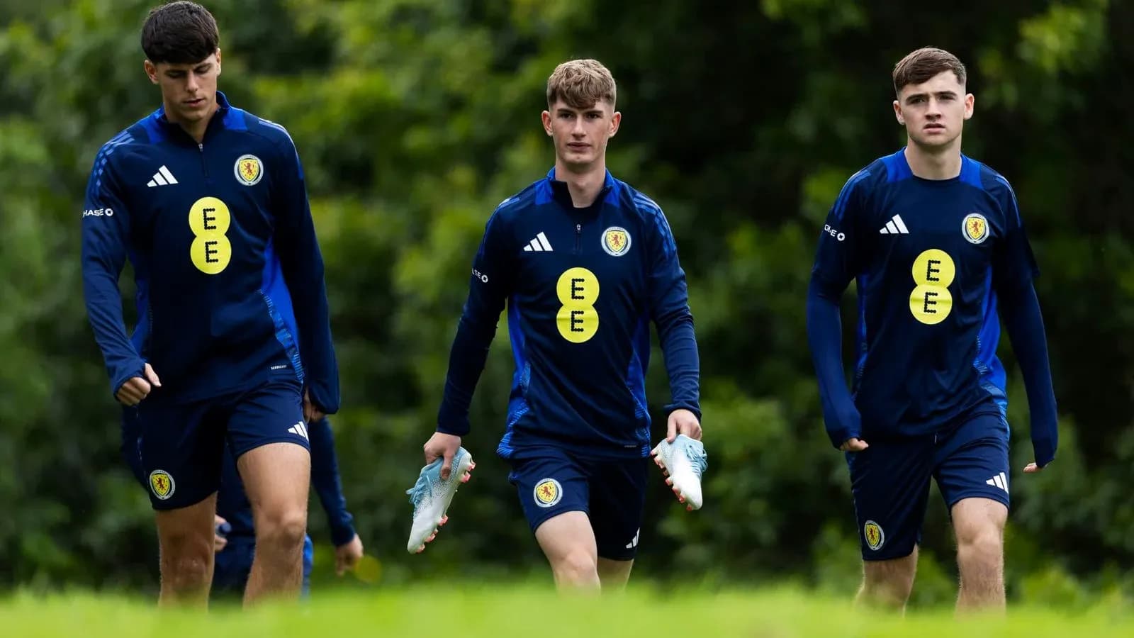 Three players walking during training session
