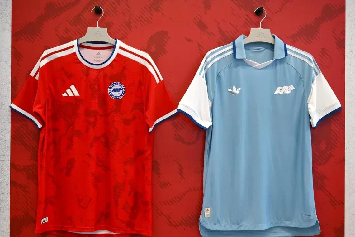 Red and blue football jerseys displayed on hangers
