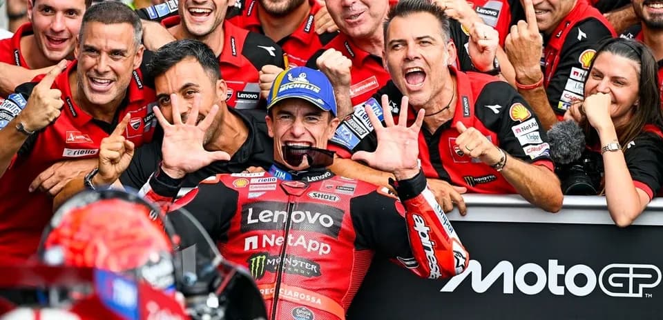 Ducati team celebrating victory with rider in garage